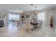 Bright living and dining area featuring stylish furniture, elegant lighting, and views of the water at 8644 Saint Kitts Cir, Englewood, FL 34224