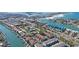 Aerial view of a coastal community with waterways, nearby beaches, and a beautiful blue sky at 903 Pinellas Bayway S # 307, Tierra Verde, FL 33715