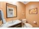 Cozy powder room boasts nautical-themed decor, single vanity, and toilet at 903 Pinellas Bayway S # 307, Tierra Verde, FL 33715