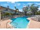 Community pool with clear blue water and lounge chairs surrounded by lush tropical landscaping at 903 Pinellas Bayway S # 307, Tierra Verde, FL 33715