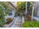 Inviting entryway with brick steps and lush tropical landscaping at 903 Pinellas Bayway S # 307, Tierra Verde, FL 33715