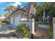 Townhome exterior features manicured landscaping, tile roof, and private entry at 903 Pinellas Bayway S # 307, Tierra Verde, FL 33715