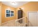 Upstairs landing features tile floors, window with shutters, and entry closet with white door at 903 Pinellas Bayway S # 307, Tierra Verde, FL 33715