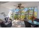 Screened patio with wicker furniture provides scenic outdoor living space at 903 Pinellas Bayway S # 307, Tierra Verde, FL 33715