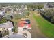 Aerial view of the property, highlighting the circular driveway, large yard, and screened-in pool area at 9234 Duffer Ct, Hudson, FL 34667