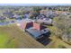 Overhead angle of a residence with a screened pool, nestled within a quiet neighborhood at 9234 Duffer Ct, Hudson, FL 34667