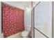 Bathroom with a red and white shower curtain and glass enclosed shower at 9234 Duffer Ct, Hudson, FL 34667