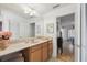 Bright bathroom with white countertops, wood cabinets, and neutral tile at 9234 Duffer Ct, Hudson, FL 34667