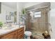 Bathroom featuring tile-surround glass shower and wood vanity at 9234 Duffer Ct, Hudson, FL 34667