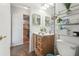 Bathroom with a wood vanity, a mirror, and a view into a home interior at 9234 Duffer Ct, Hudson, FL 34667