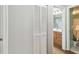 Hallway view into bathroom featuring a wooden vanity at 9234 Duffer Ct, Hudson, FL 34667