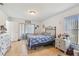 Light-filled bedroom with wood laminate floors and neutral paint at 9234 Duffer Ct, Hudson, FL 34667