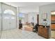 Welcoming front foyer featuring tile flooring and a full view of the dining room and front door at 9234 Duffer Ct, Hudson, FL 34667