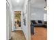 Hallway leading to playroom and living room with gray sofa at 9234 Duffer Ct, Hudson, FL 34667