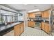 Bright kitchen featuring a sink with a view, stainless steel appliances, and light wood cabinets at 9234 Duffer Ct, Hudson, FL 34667