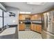 Well-lit kitchen with stainless steel appliances, wooden cabinets, and a large sink area with natural light at 9234 Duffer Ct, Hudson, FL 34667