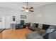 Living room featuring laminate wood flooring, dark gray furnishings, and neutral decor at 9234 Duffer Ct, Hudson, FL 34667