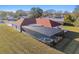 Elevated perspective of screened-in pool and hot tub, surrounded by manicured landscaping at 9234 Duffer Ct, Hudson, FL 34667