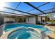 Beautiful pool and hot tub, screened-in lanai, perfect for outdoor relaxation and entertainment at 9234 Duffer Ct, Hudson, FL 34667