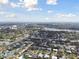 Expansive aerial view of a residential area, showcasing houses near a lake, and cityscape in the distance at 969 Britton St, Largo, FL 33770