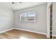 Cozy bedroom features modern floors, neutral walls, baseboard trim, and a large window at 969 Britton St, Largo, FL 33770