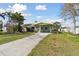 Cozy single-story home features a well-maintained lawn, mature landscaping, and a covered entry at 969 Britton St, Largo, FL 33770