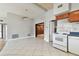 Eat-in kitchen featuring white appliances, wood cabinets, and tile floors at 969 Britton St, Largo, FL 33770