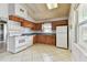 Functional kitchen with white appliances and wood cabinets at 969 Britton St, Largo, FL 33770