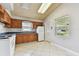 Well-lit kitchen with white appliances, wood cabinetry, and tile flooring at 969 Britton St, Largo, FL 33770