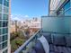 Balcony view showcasing city skyline with greenery and an outdoor lounge area at 111 N 12Th St # 1820, Tampa, FL 33602