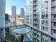 Balcony view showcasing city skyline with high-rise buildings and an outdoor lounge area at 111 N 12Th St # 1820, Tampa, FL 33602