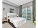 Serene bedroom features a large window with views, soft lighting, and minimalist decor at 111 N 12Th St # 1820, Tampa, FL 33602