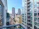 Balcony view featuring city skyline with high-rise buildings and an outdoor lounge area at 111 N 12Th St # 1820, Tampa, FL 33602