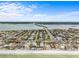 Aerial view of a waterfront community and neighborhood featuring a nearby pond and ocean access at 114 12Th St, Belleair Beach, FL 33786