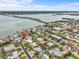 Enjoy serene water views from this lovely home with lush landscaping, great neighborhood, and easy access to the bridge at 114 12Th St, Belleair Beach, FL 33786