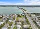 Picturesque aerial view of a bridge over a serene waterway, surrounded by lush greenery and charming residential areas at 114 12Th St, Belleair Beach, FL 33786