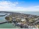 Beautiful aerial perspective of a neighborhood with waterfront access, featuring homes near a serene pond and waterway at 114 12Th St, Belleair Beach, FL 33786