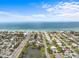 Scenic aerial view of a residential area and a pond, showcasing homes in close proximity to the beach at 114 12Th St, Belleair Beach, FL 33786