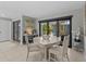 Bright dining room with decorative accents, sliding glass doors, and tile flooring at 114 12Th St, Belleair Beach, FL 33786