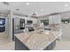 Modern kitchen with stainless steel appliances, quartz countertops, and a gray island at 114 12Th St, Belleair Beach, FL 33786