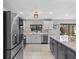 Well-equipped kitchen featuring modern appliances, quartz countertops, and ample lighting at 114 12Th St, Belleair Beach, FL 33786