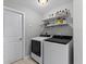 Clean laundry room with white appliances and shelf storage at 114 12Th St, Belleair Beach, FL 33786