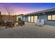 Cozy patio with pavers, an outdoor seating area, and string lights for evening ambiance at 114 12Th St, Belleair Beach, FL 33786