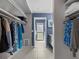 Walk-in closet with hanging rods and shelves, leading to the ensuite bathroom at 114 12Th St, Belleair Beach, FL 33786