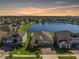 Sunset aerial view of waterfront home featuring lush landscaping and picturesque water views at 11717 Navajo Sandstone St, Riverview, FL 33579