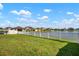 Well-maintained backyard featuring a white fence along a scenic lake at 11717 Navajo Sandstone St, Riverview, FL 33579