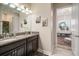 Beautiful bathroom featuring granite countertops, double sinks, decorative art, and plenty of natural light at 11717 Navajo Sandstone St, Riverview, FL 33579