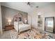 Well-lit bedroom featuring a canopy bed, stylish furnishings and ensuite bath at 11717 Navajo Sandstone St, Riverview, FL 33579