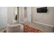 Another view of the bedroom with a chair, colorful rug and mounted TV, offering potential for customization at 11717 Navajo Sandstone St, Riverview, FL 33579