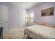 Bright bedroom with neutral walls, carpet and large window, offering a peaceful and comfortable retreat at 11717 Navajo Sandstone St, Riverview, FL 33579